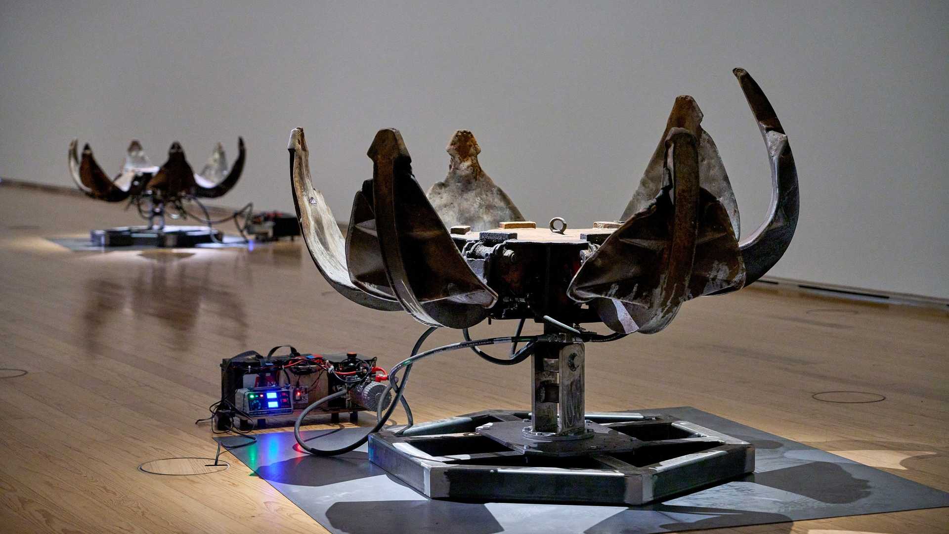 An exhibition with flowers made of car pieces