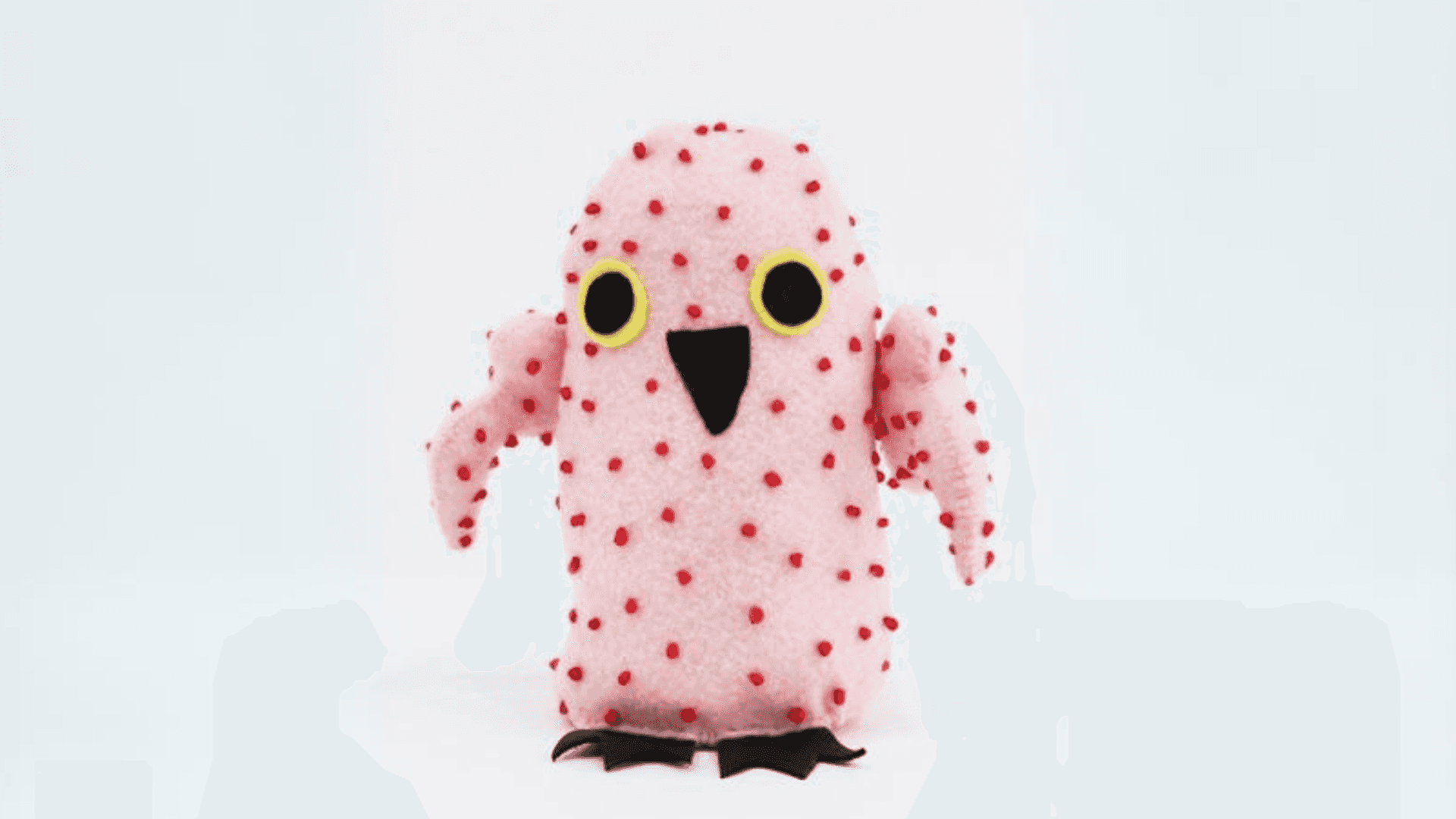 Sitting bird made out of pink fabric