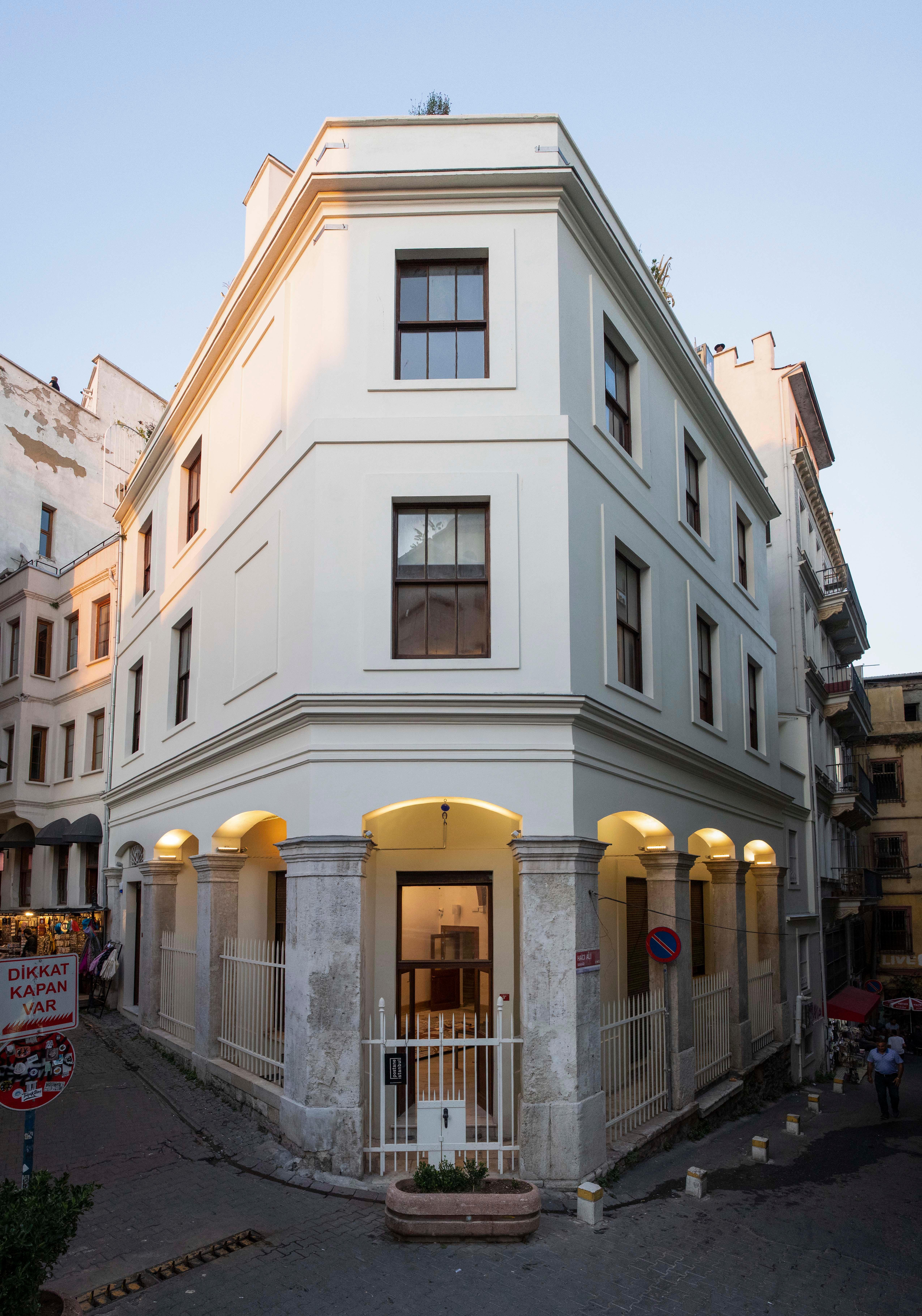 A white building with three floors is shown.