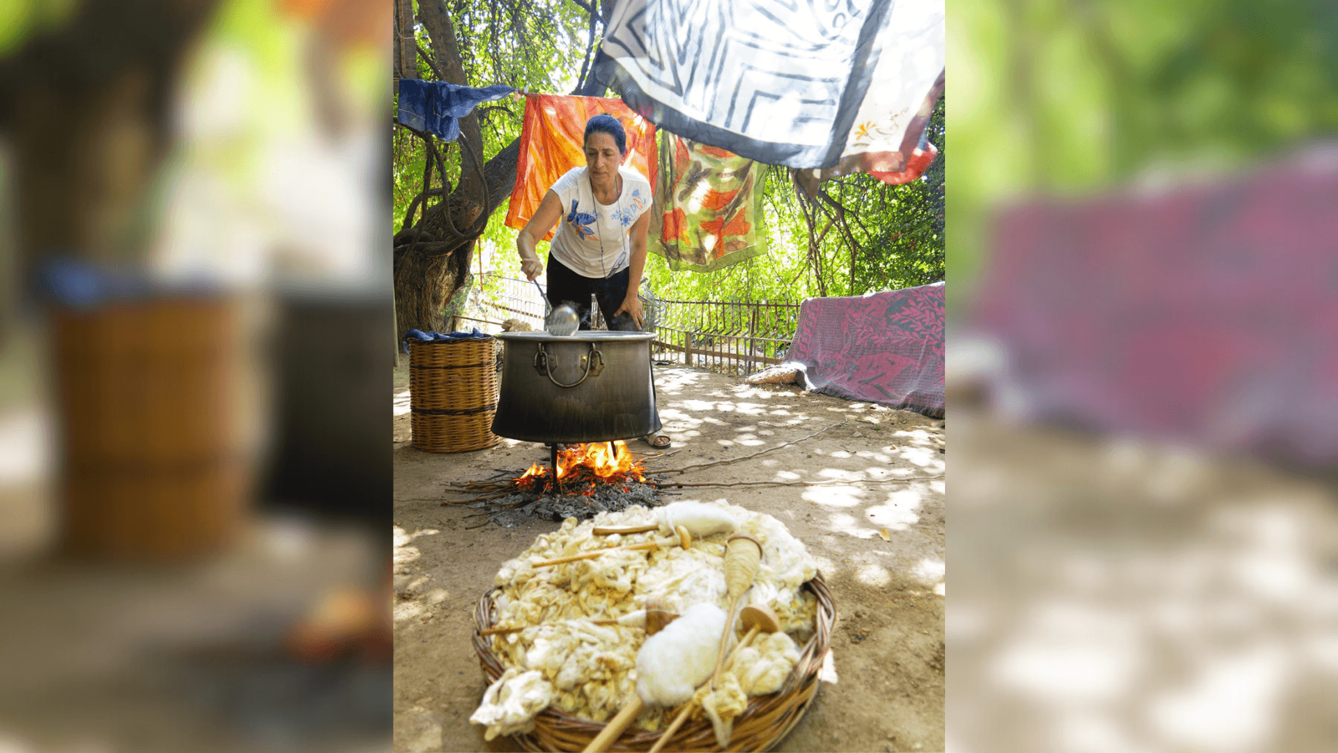 A person producing silk outdoors