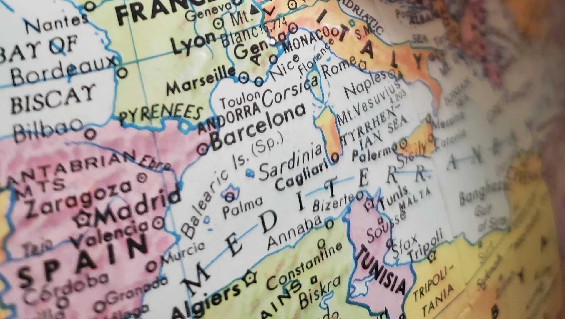 A finger is pointing on a map on germany