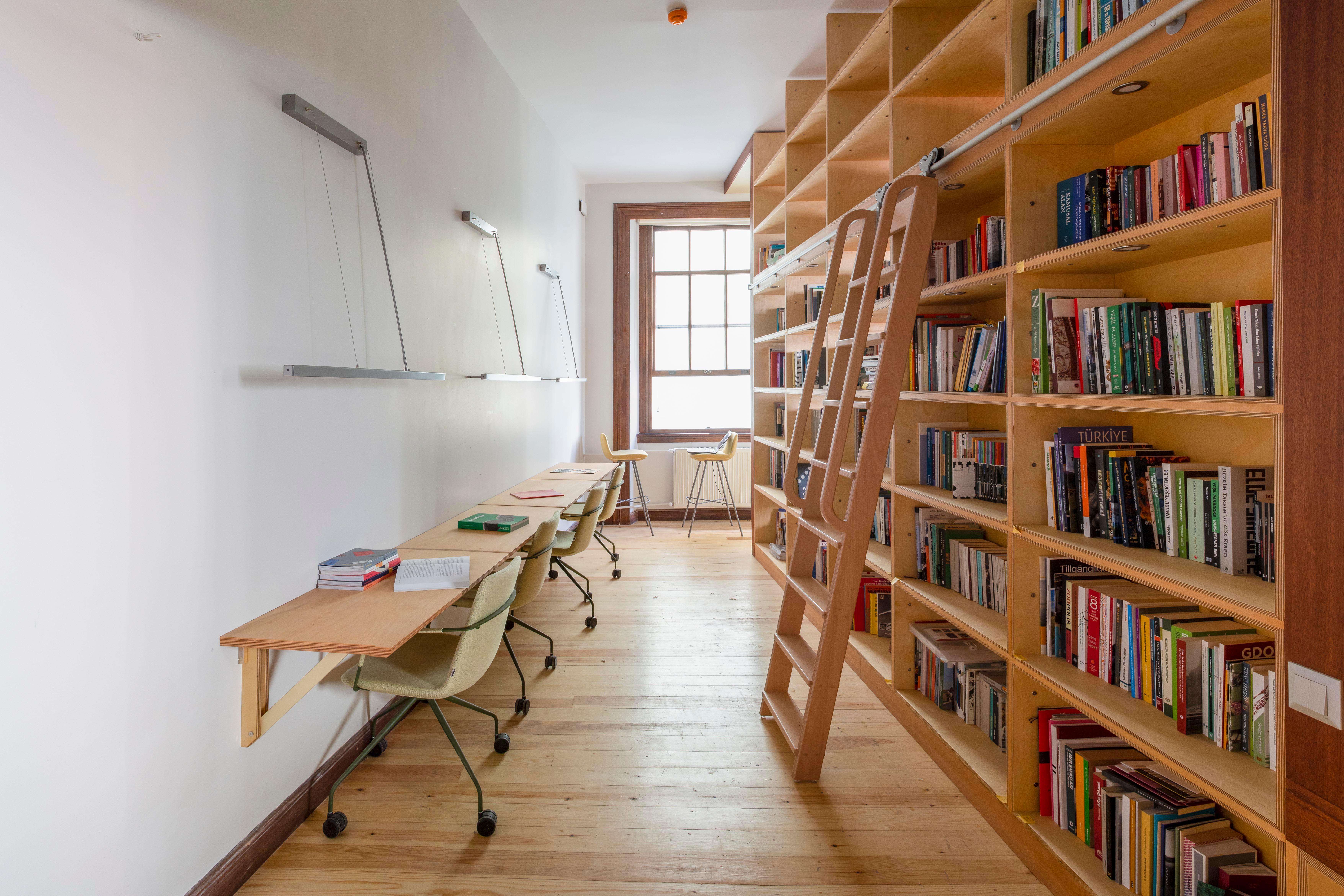 A room with many books in a big shelf