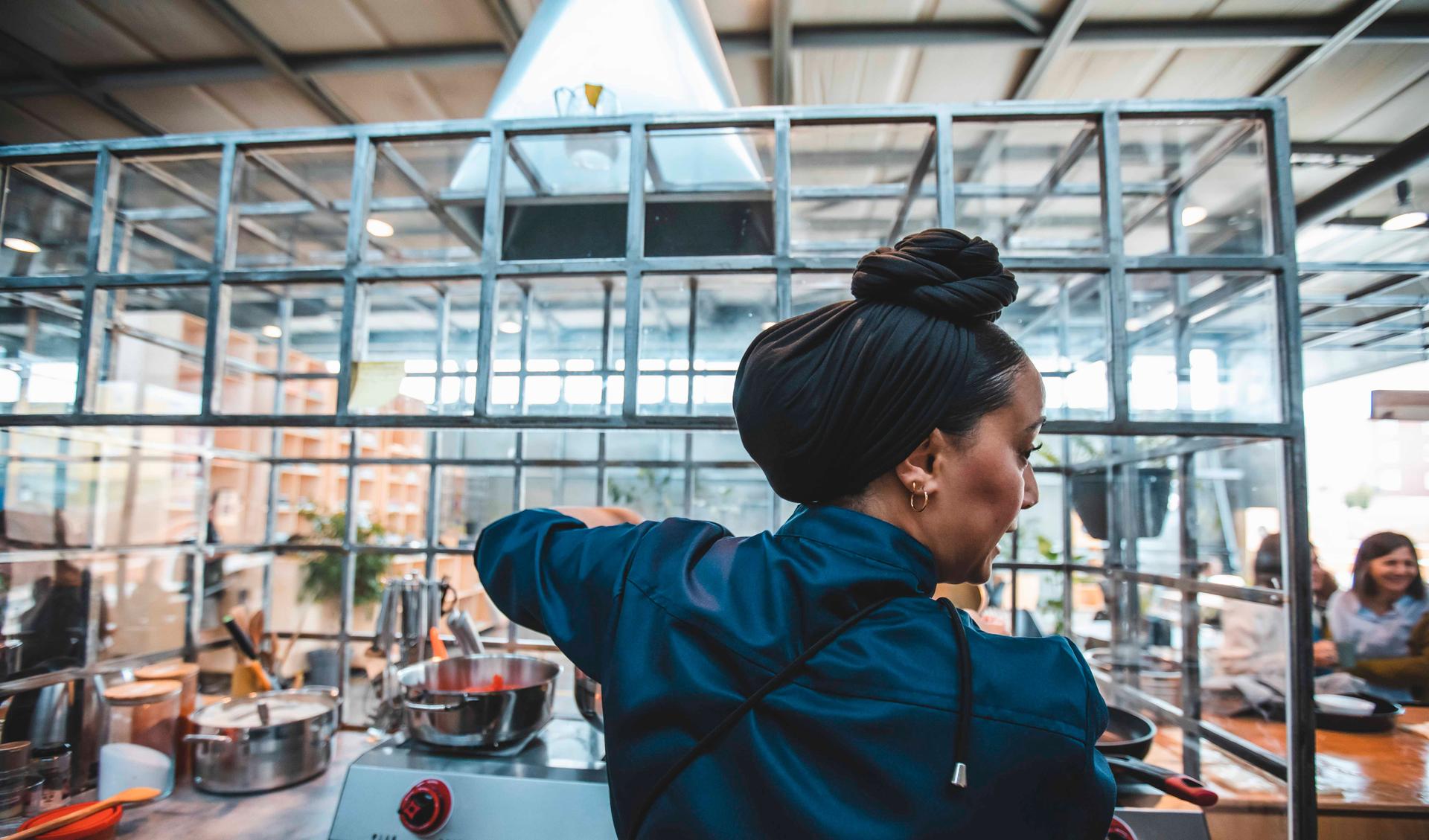 Chef Imane El Bakali from Recyclart cooking in Autostrada Hangar