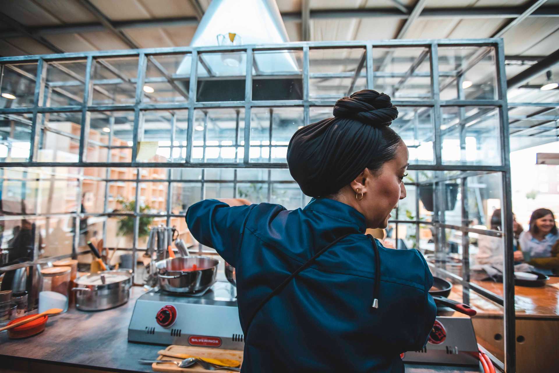 Chef Imane El Bakali from Recyclart cooking in Autostrada Hangar