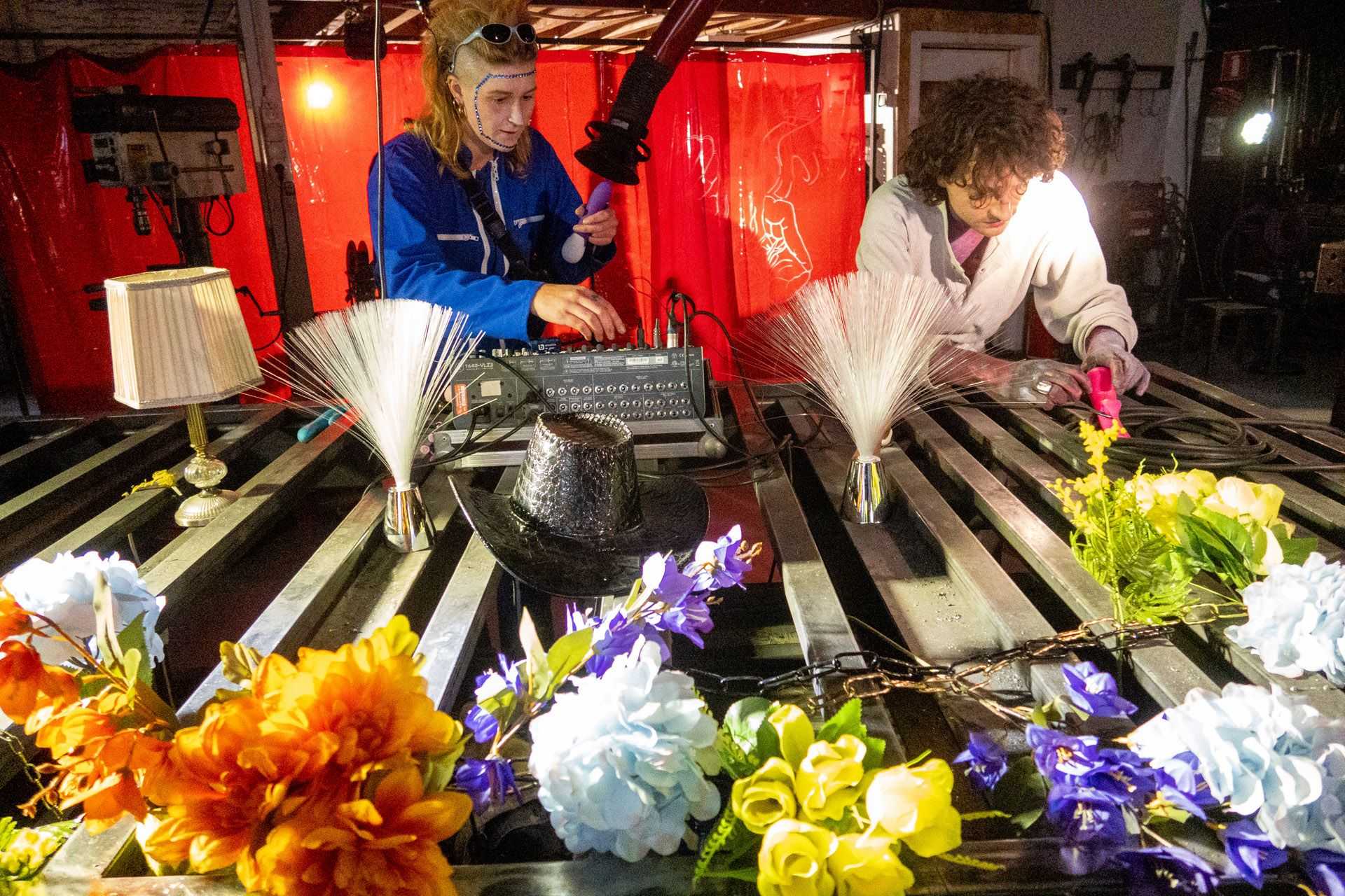 Two persons are preparing to play music and are performing art