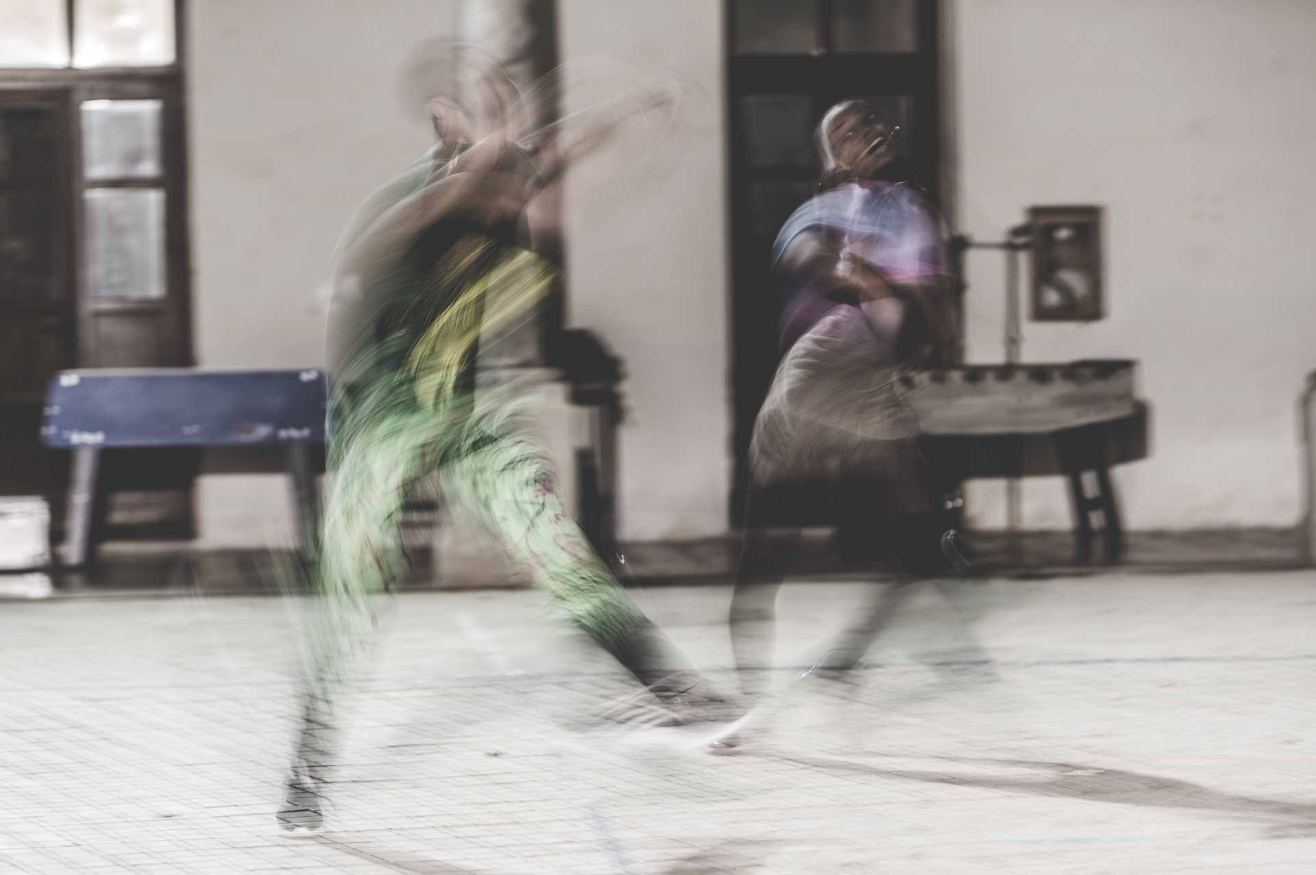 two people are dancing so fast, that on the picture just fragments of the dancing persons are recognizable