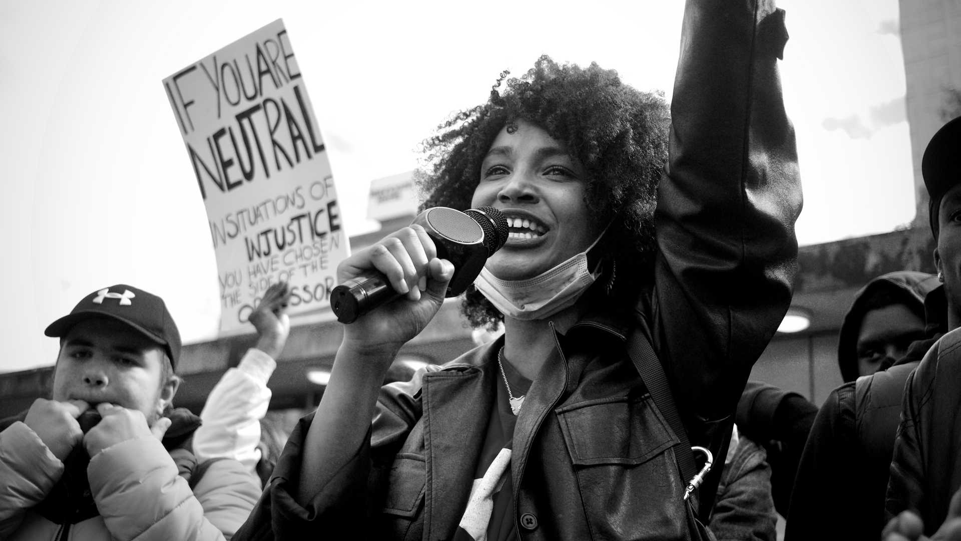 A person on a demonstration speaks into a micro