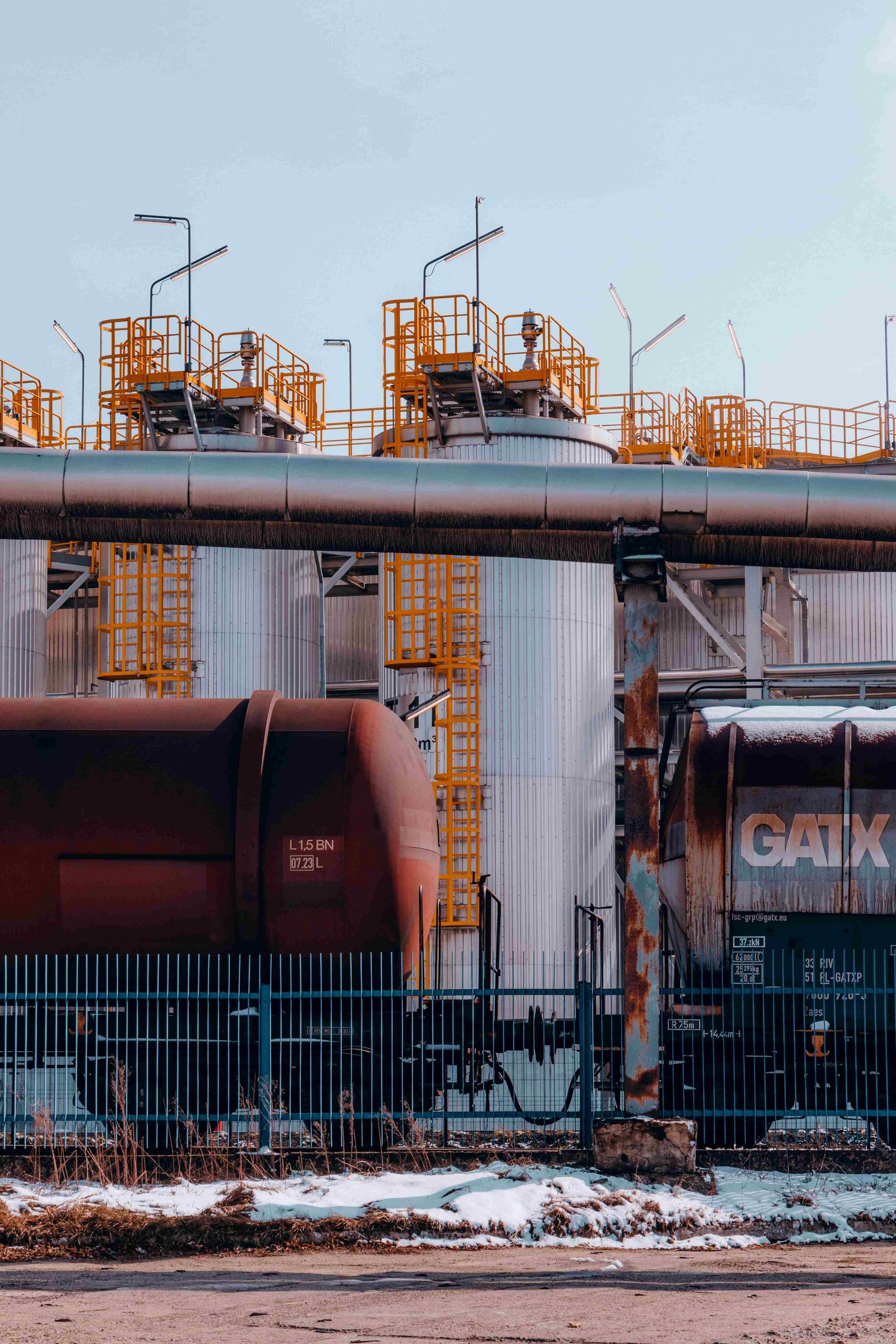 Tanker cars in front of a refinery