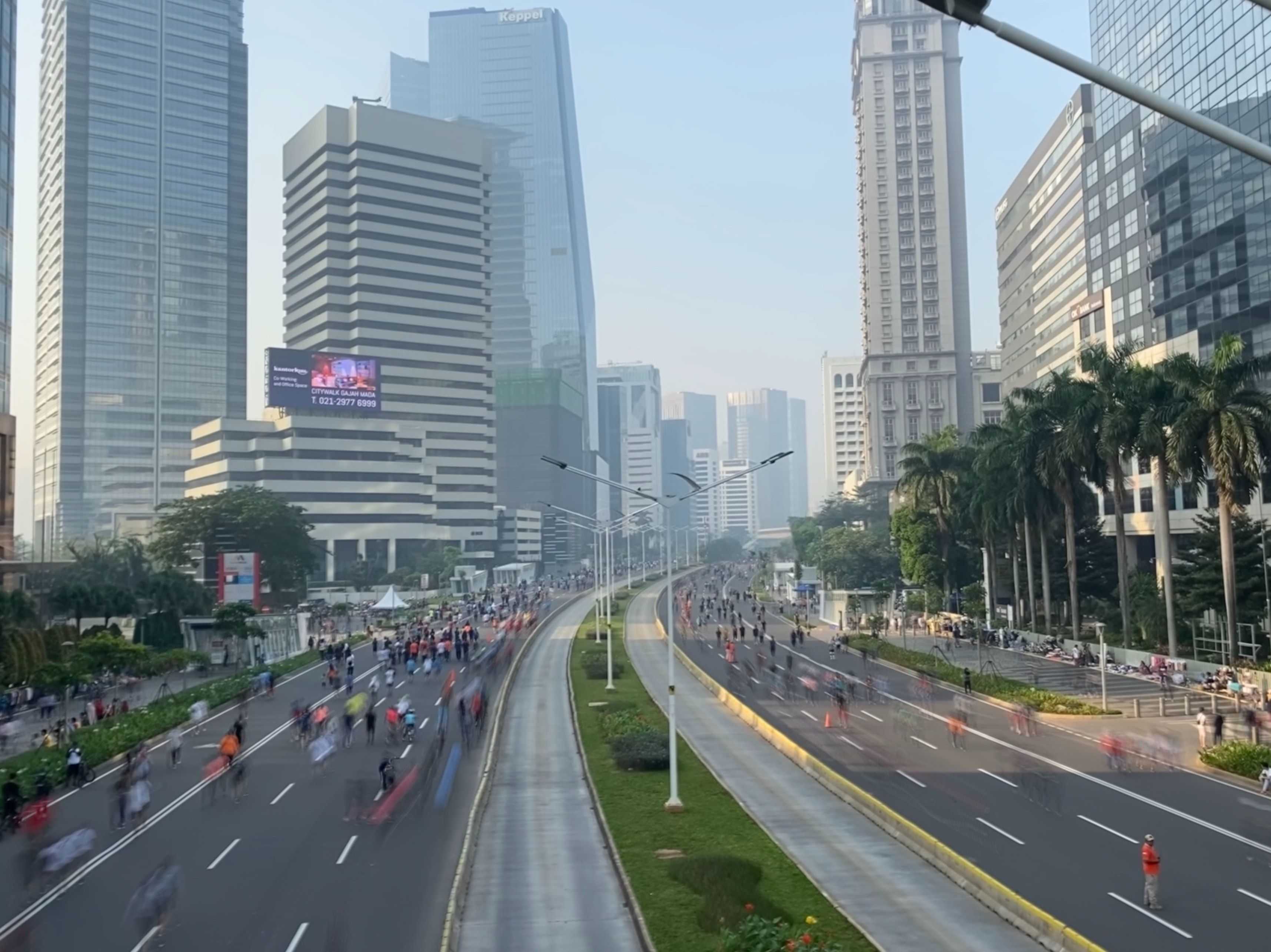 Big streets in Jakarta are free from cars. Many people and bicycles are on the streets