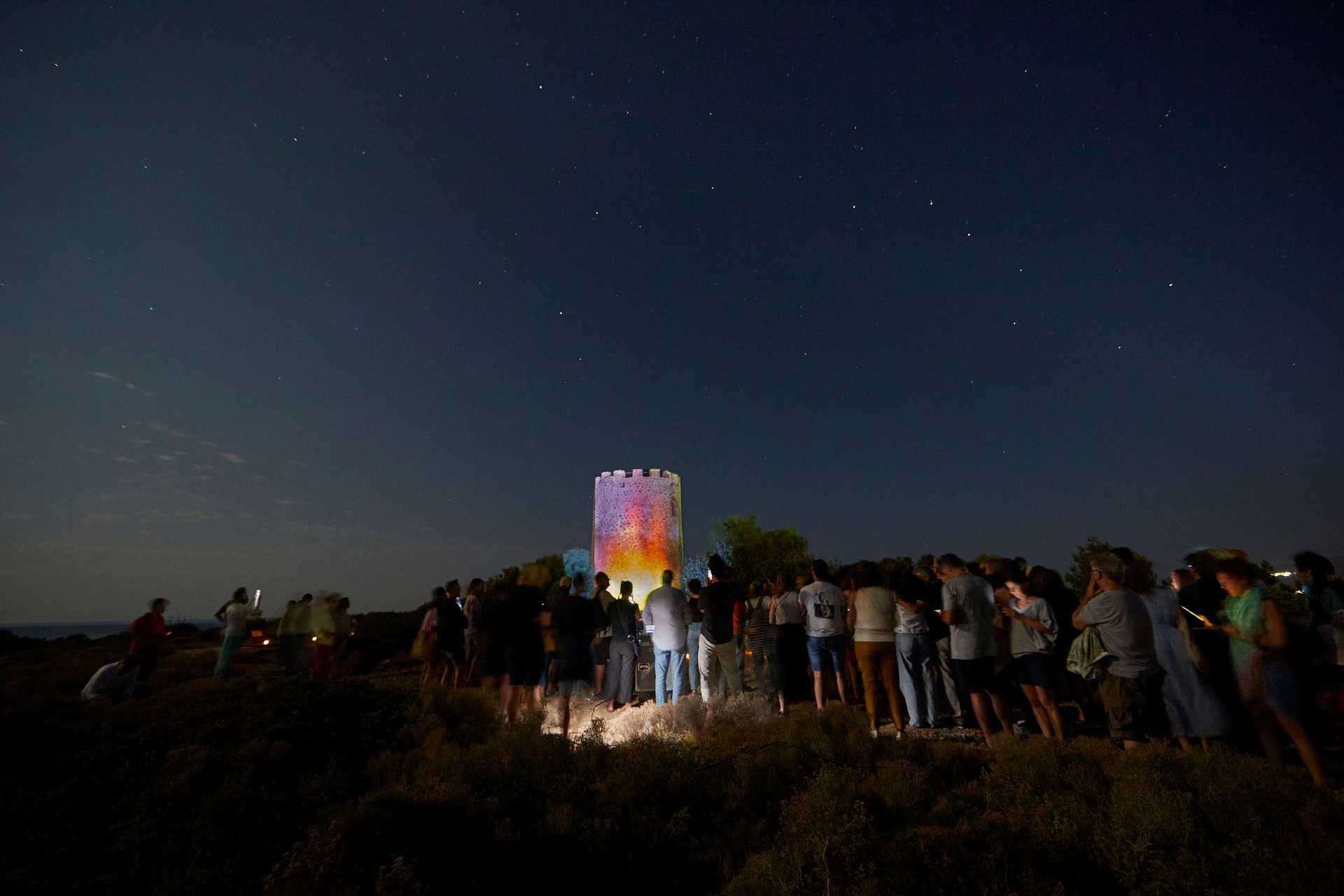 A crowd is watching a performance at the festival