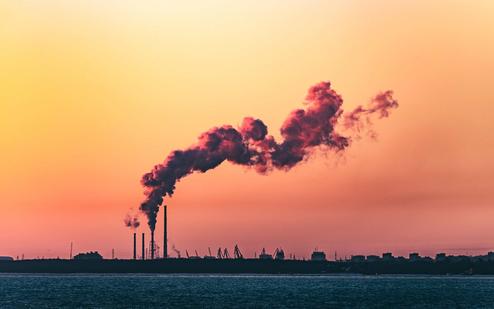 The coastline of Gdanks in poland. An industrial shimney smokes