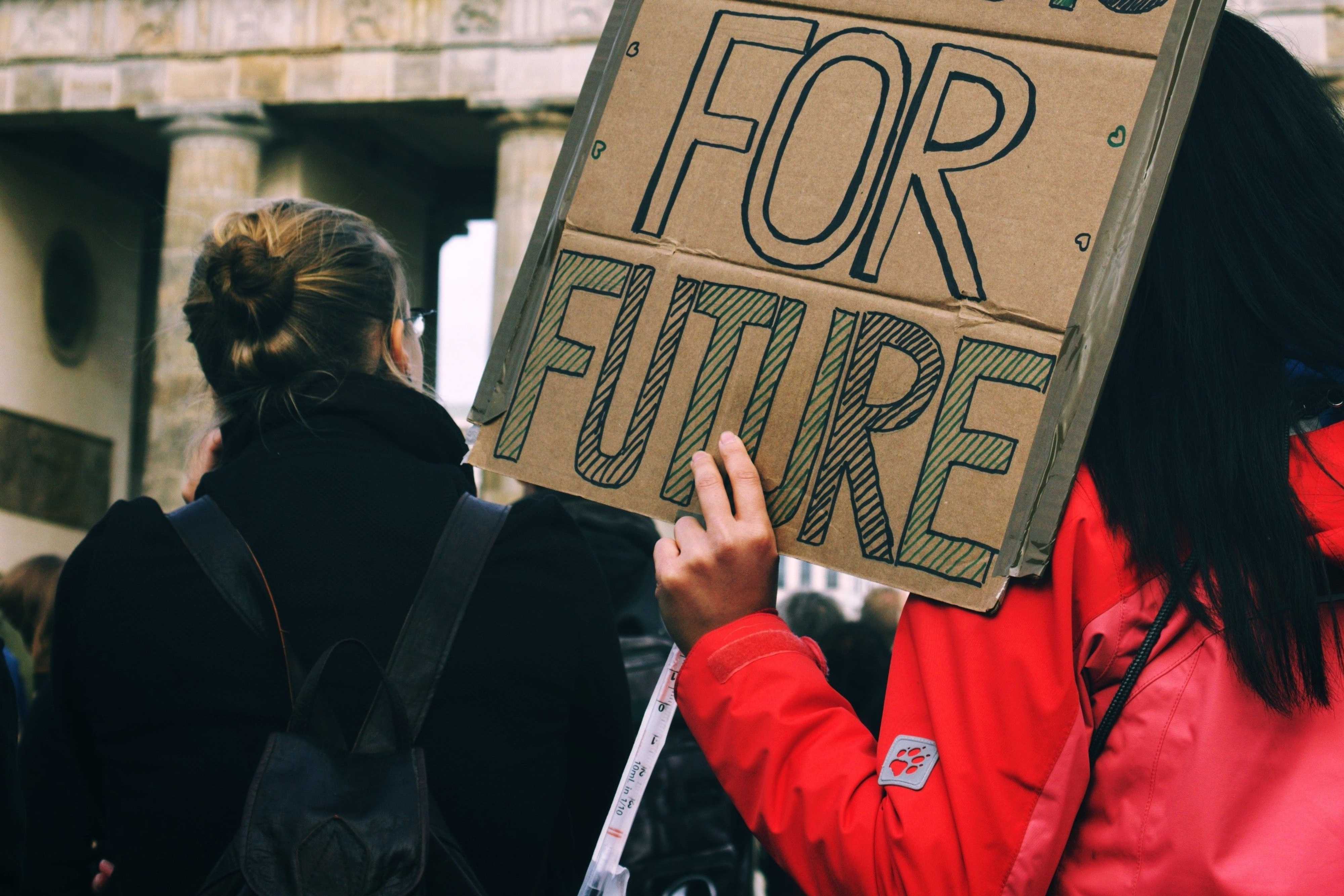 A person is hoding a selmade protest slogan on which "For Future" is written.