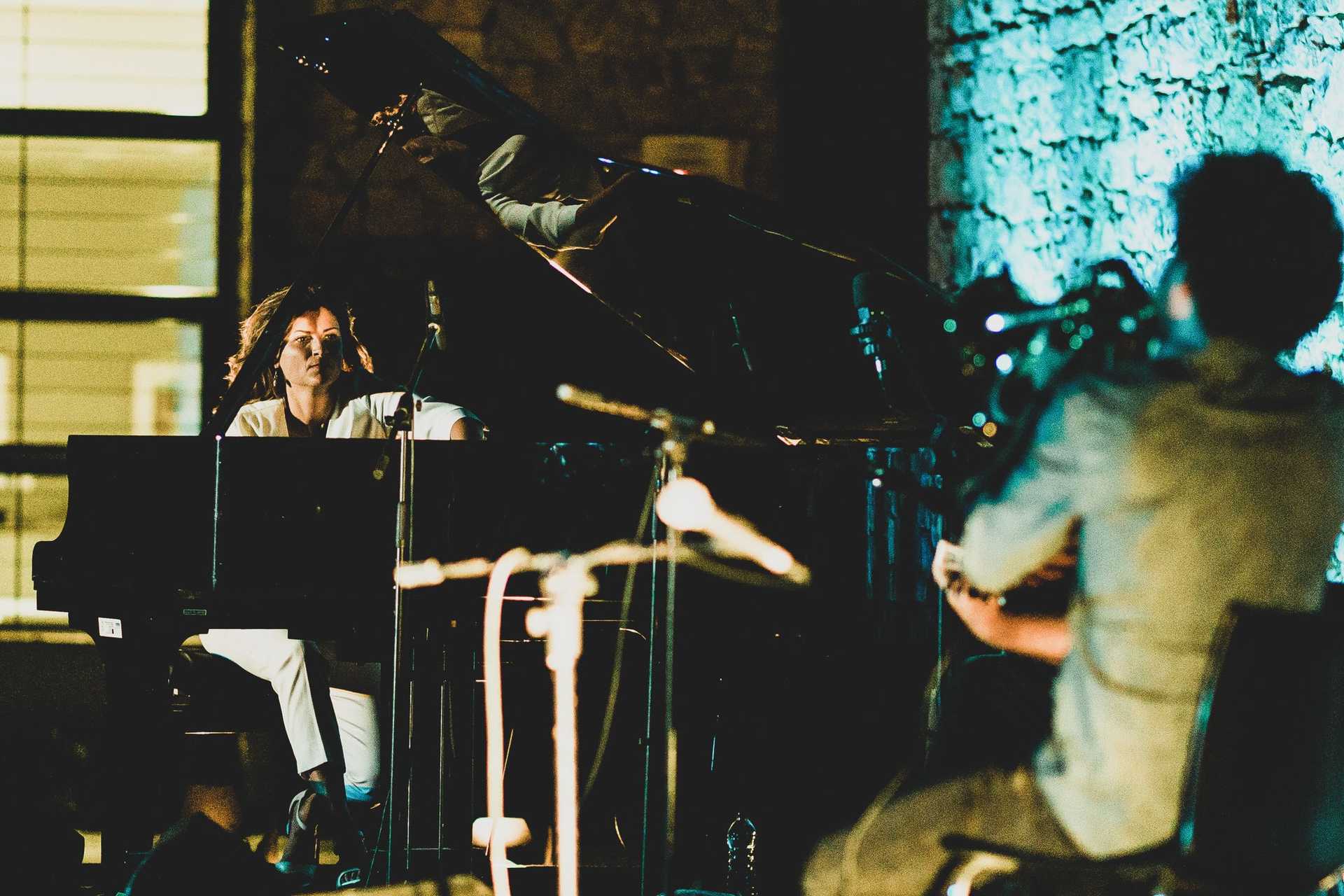 Two musicians are playing their instruments