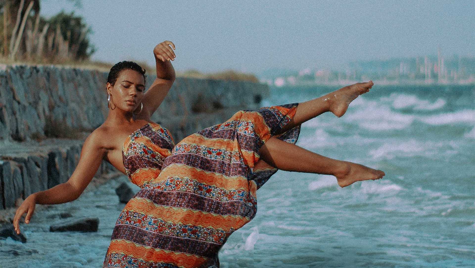 A woman hovers over waves and water