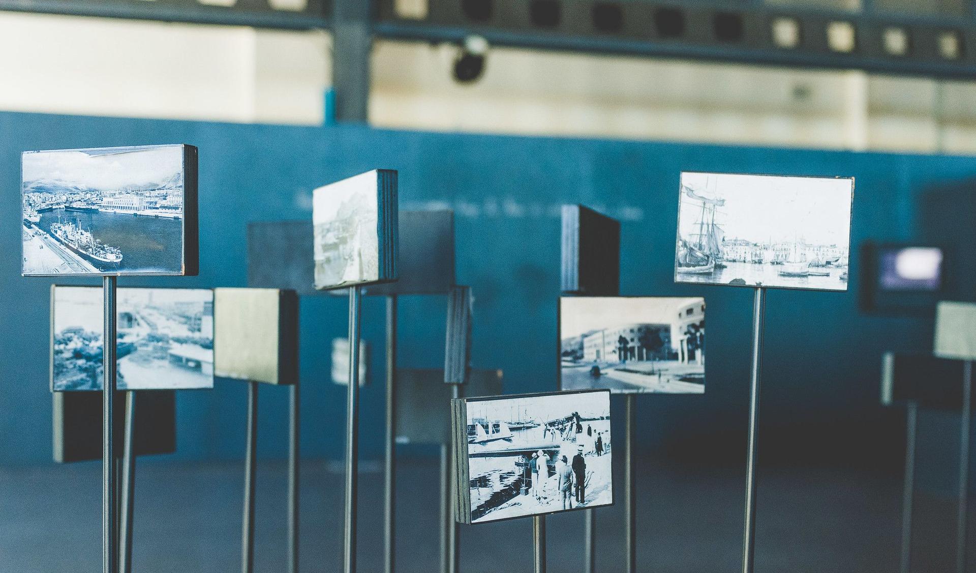 Pictures on metal rods are displayed in an exhibition