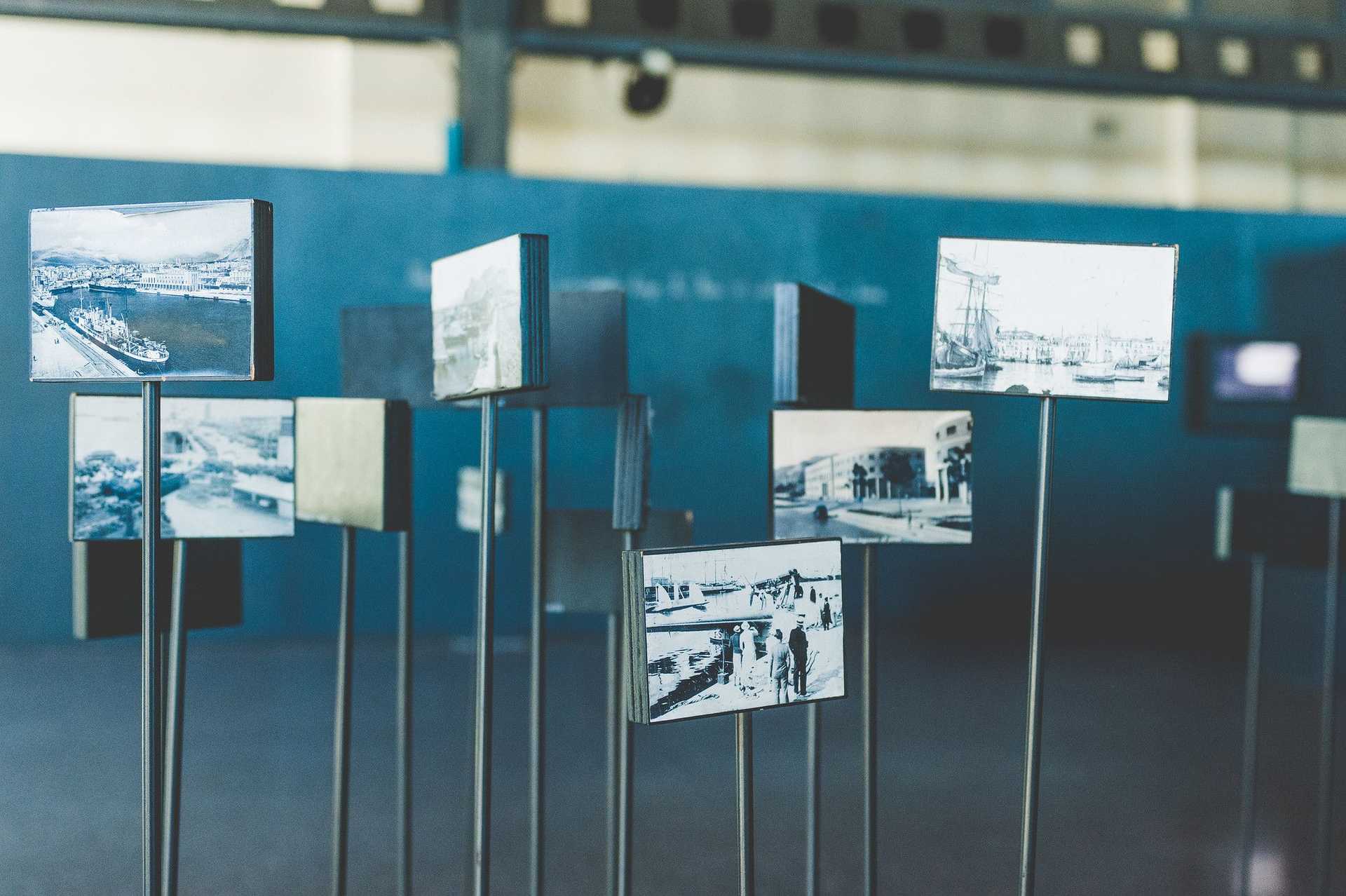 Pictures on metal rods are displayed in an exhibition