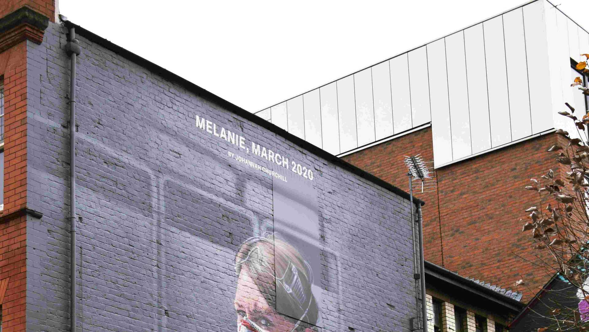 A mural of a NHS worker with a Covid-mask on a wall in UK