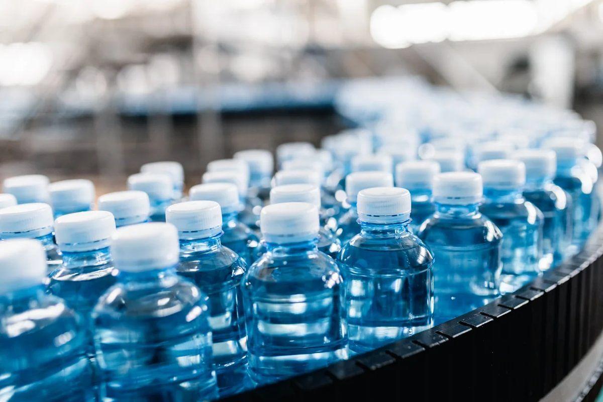 A row of plastic bottles in a factory