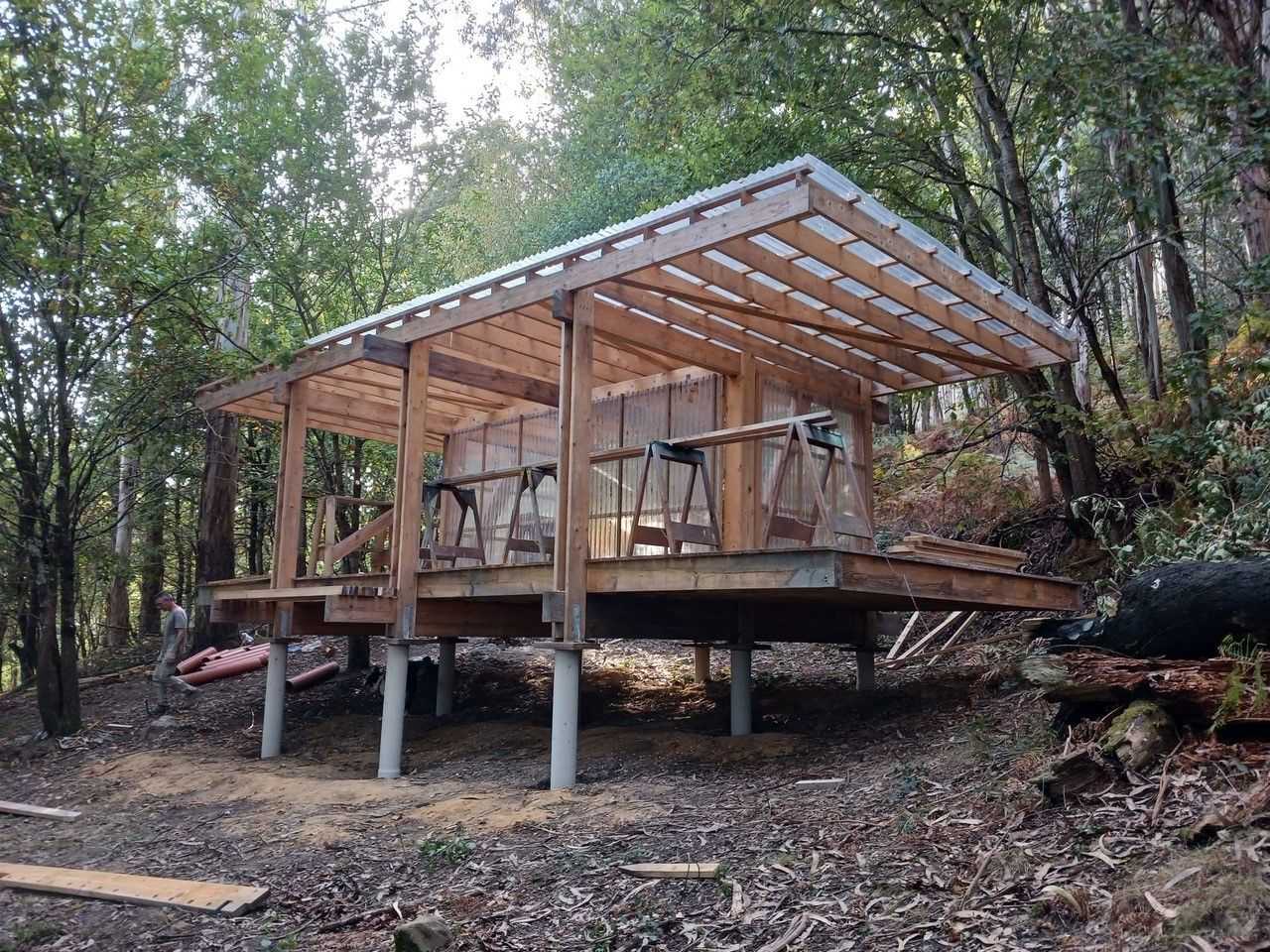 A wooden hut in the woods is under construction