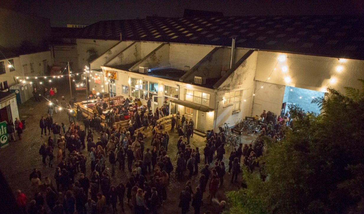 The site of the Hub pictured from above with many people standing in the courtyard